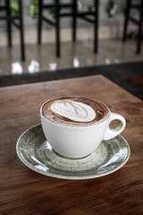 A cup of coffee with latte art on top