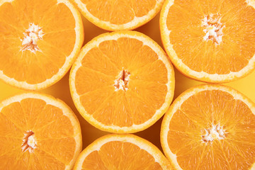 Orange on an orange background. Halves of juicy orange.