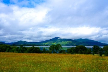 Fototapeta premium Beautiful Irish landscape with peaceful lake and rugged mountain.