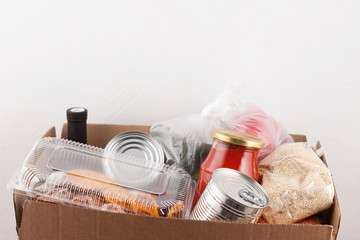 Close-up cardboard box with food products. Social food donation. Safe contactless home food...