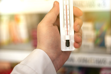 thermometer in the hand of a medic