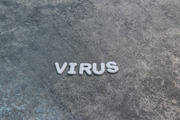 virus written out on gray background with white lettering