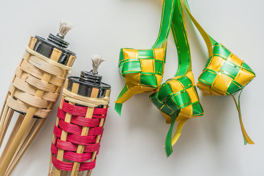 Ketupat decoration and Bamboo lamp or pelita buluh over white background. Eid mubarak festival