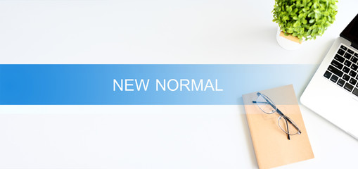 NEW NORMAL word on the desk Business