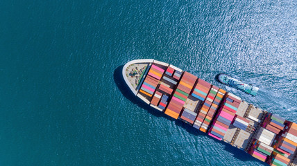 Aerial top view of cargo ship carrying container and running for export  goods  from  cargo yard...