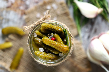 Selective focus. Macro. Pickled Gherkins. Jar with gherkins. Salt and spec.