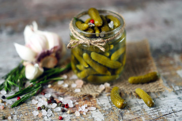 Selective focus. Macro. Pickled Gherkins. Jar with gherkins. Salt and spec.