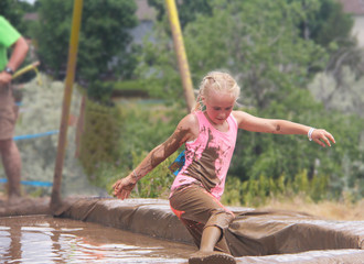 mud running run outside outdoors activities pink shirt active clothes blonde braid