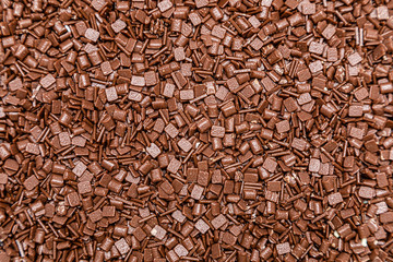Granulated milk chocolate texture background