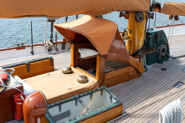 Deck of an old sail boat showing below deck access by the central mast, sailing vessel details, horizontal aspect