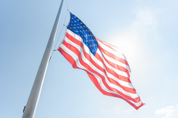 american flag against blue sky