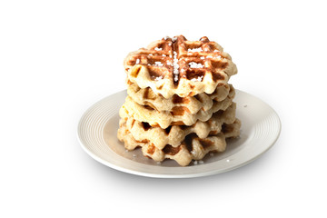 belgian waffle over a white plate with sugar