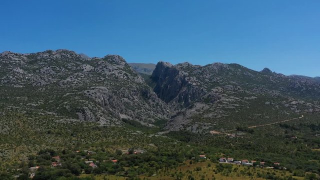 Paklenica Canyon in South Velebit Mountain with Vaganski Peak behind - Aerial Panoramic Blue Sky View
