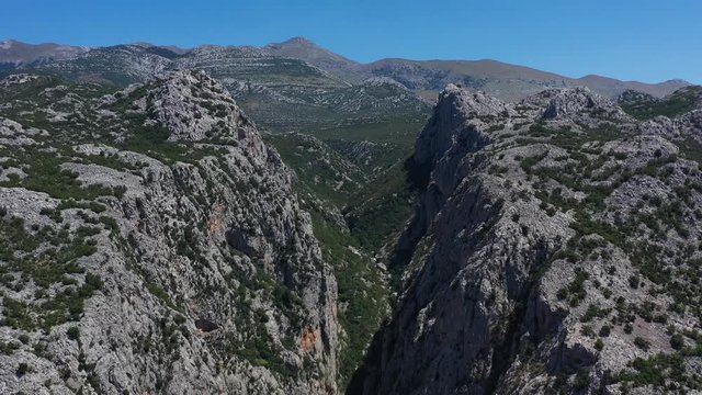 Paklenica Canyon in South Velebit Mountain revealing Vaganski Peak behind - Aerial Panoramic Blue Sky View