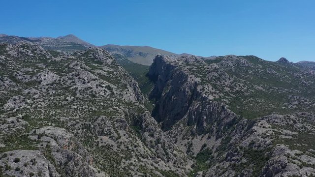 Paklenica Canyon in South Velebit Mountain with Vaganski Peak behind - Aerial Panoramic Blue Sky View