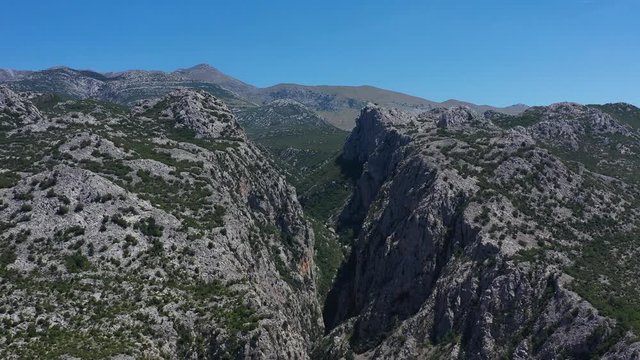 Paklenica Canyon in South Velebit Mountain with Vaganski Peak behind - Aerial Panoramic Blue Sky View