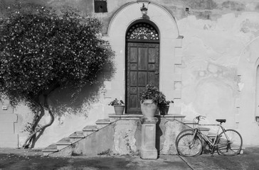 Classic, common Sicilian doorway with bicycle in black and white