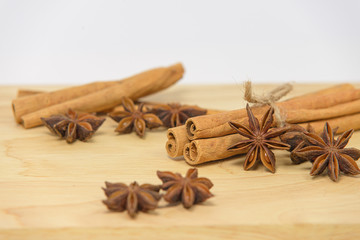 Cinnamon sticks and star anise spice on wooden board