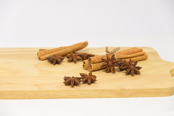 Cinnamon sticks and star anise spice on wooden board