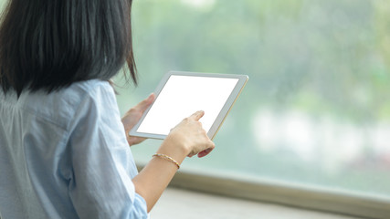 woman using a tablet pc with blank white desktop screen