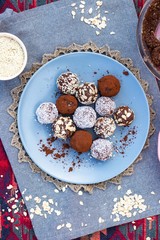 Chocolate truffle coconut protein vegan balls. Sweet breakfast dessert ingredients on table.