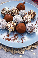 Chocolate truffle coconut protein vegan balls. Sweet breakfast dessert ingredients on table.