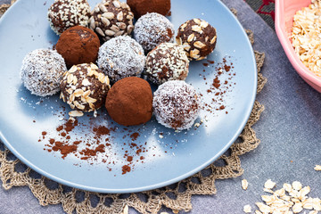 Chocolate truffle coconut protein vegan balls. Sweet breakfast dessert ingredients on table.