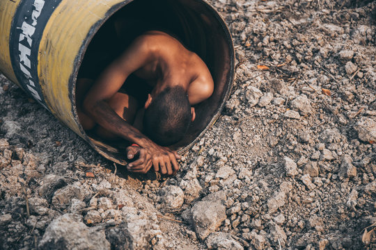 Poor People,homeless Or Beggar Begging For Help Sitting At Dirty Slum.concept For Poverty Hunger,human Rights,donate And Charity For Underprivileged Children In Third World