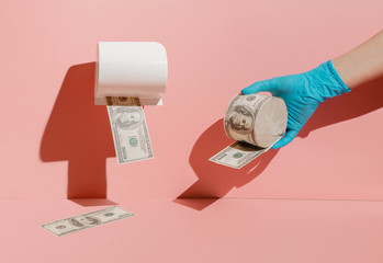 Creative concept of the economic crisis of 2020, monetary inflation during the coronavirus. The photo shows dollars, toilet paper and protective gloves.