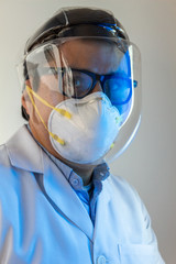 Person with glasses, face protection mask and respiratory protection mask