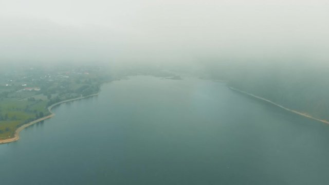 Lake Izvorul Muntelui, Neamt, Romania - Lift down from the clouds - Drone filming