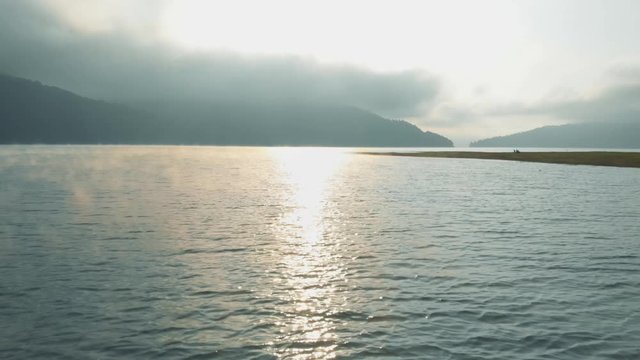 Reservoir Izvorul Muntelui, Neamt, Romania - Dolly in over the lake in the sunrise light