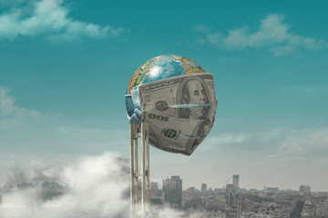 Creative concept of the 2020 economic crisis, money inflation during the coronavirus, unemployment. The photo shows a medical mask of dollars on a globe