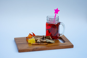 A mason jar of herbal drinks with various herbs ingredients white background.