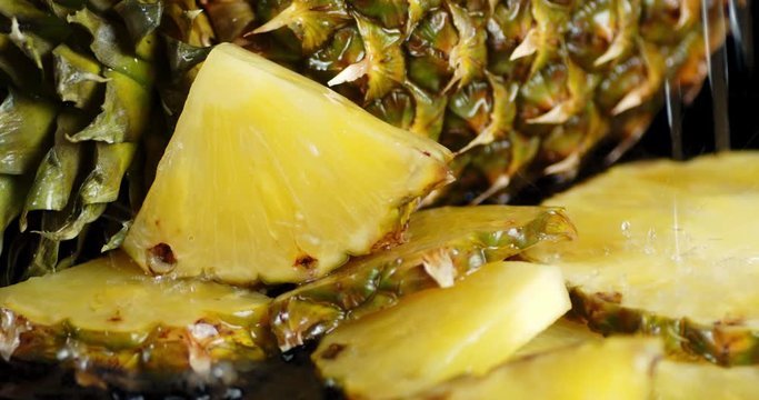 The fragrant pieces of pineapple falling water drops.