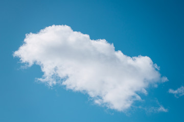 Single cloud flying in the deep blue sky
