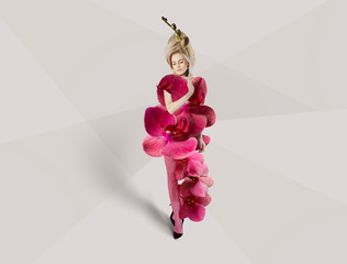 Creative Concept of women's dresses. Model in a luxurious floral dress. Women's evening fashion