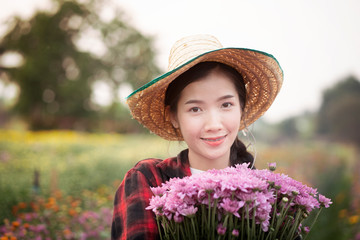 beautiful woman holding flower in garden