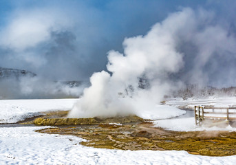 Yellowstone National Park with geothermal geyer during winter
