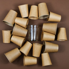 Zero waste concept. Eco-friendly, disposable, cardboard, paper dishes against glass reusable dishes.