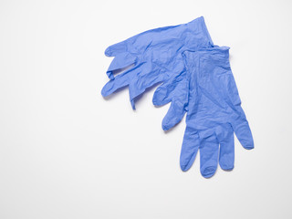 Pair of Disposable Blue Gloves on White Background. Photographed with a shallow depth of field with copy space.
