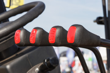 Operating control levers and steering wheel in loader machine