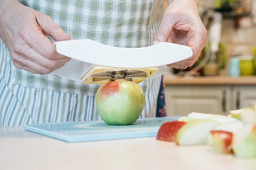A green apple on a cutting board with a cake on a plate