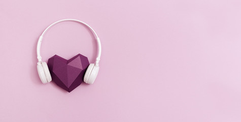 3d purple paper heart in white headphones. Concept for music festivals, radio stations, music lovers.  Live with music. Minimal style. Banner with copy space.