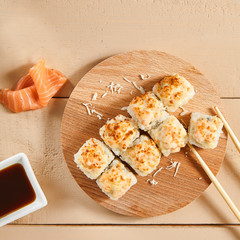 Baked shrimp rolls on wooden board top view