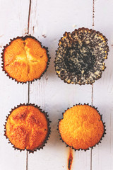 Tasty homemade lemon muffins in black baking paper cup with empty one