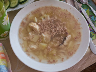 White plate of fish soup made of burbot and liver.