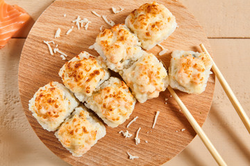 Baked shrimp rolls on wooden board top view
