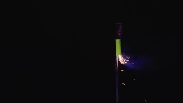 Starting fireworks rocket with lighter in hand, safe pyrotechnics
