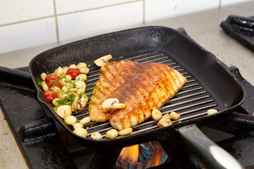 Grilled fish on a pan with boiled corn